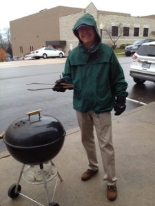 team member with grill outside