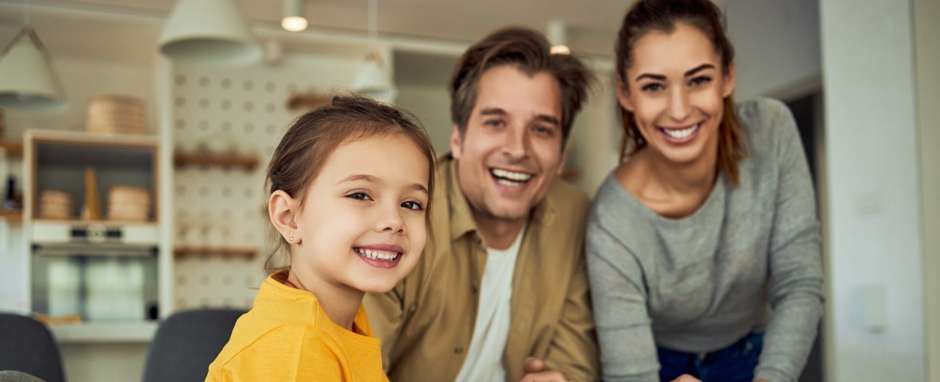 Happy adoptive family with child at home representing successful adoption process in Central Missouri