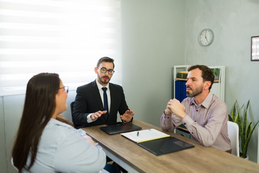 Divorce attorney explaining contested divorce trial process to separating couple during legal consultation at Brydon Swearengen England Jefferson City Missouri